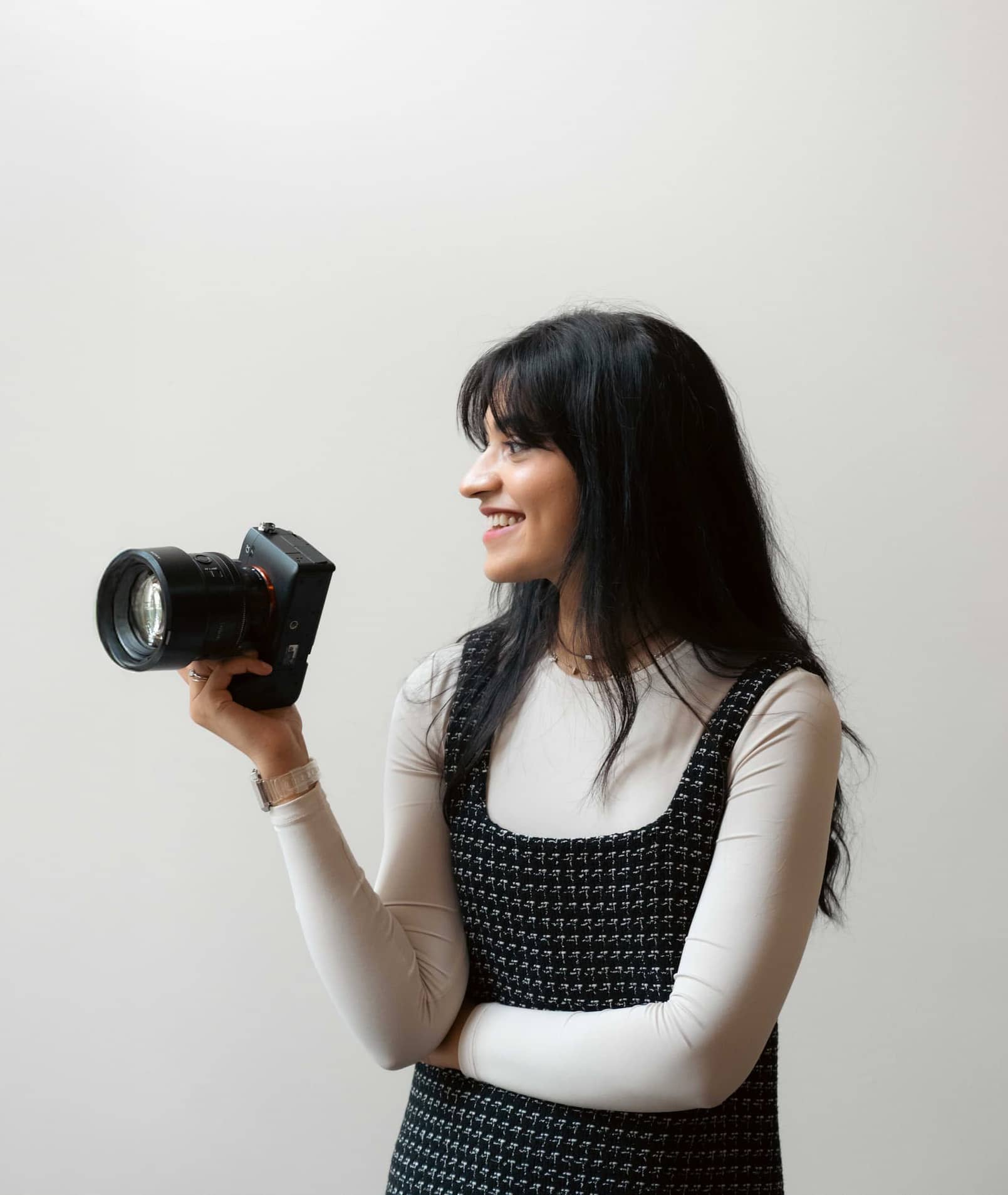 Amna, photographer at Photos by Amna, holding her camera